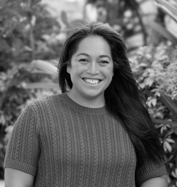 Suzi Le Fanue, smiling in a natural setting, showcasing her role as a Naturopath and Clinic Founder at Integrated Wellness Clinic.