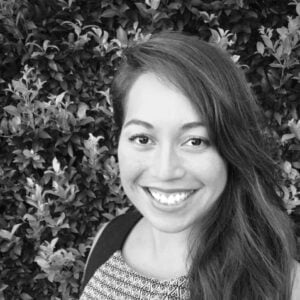 Arabella Richards, Clinical Naturopath at Integrated Wellness Clinic, smiling against a backdrop of greenery, emphasizing her focus on gut health, hormonal balance, and mental wellness.