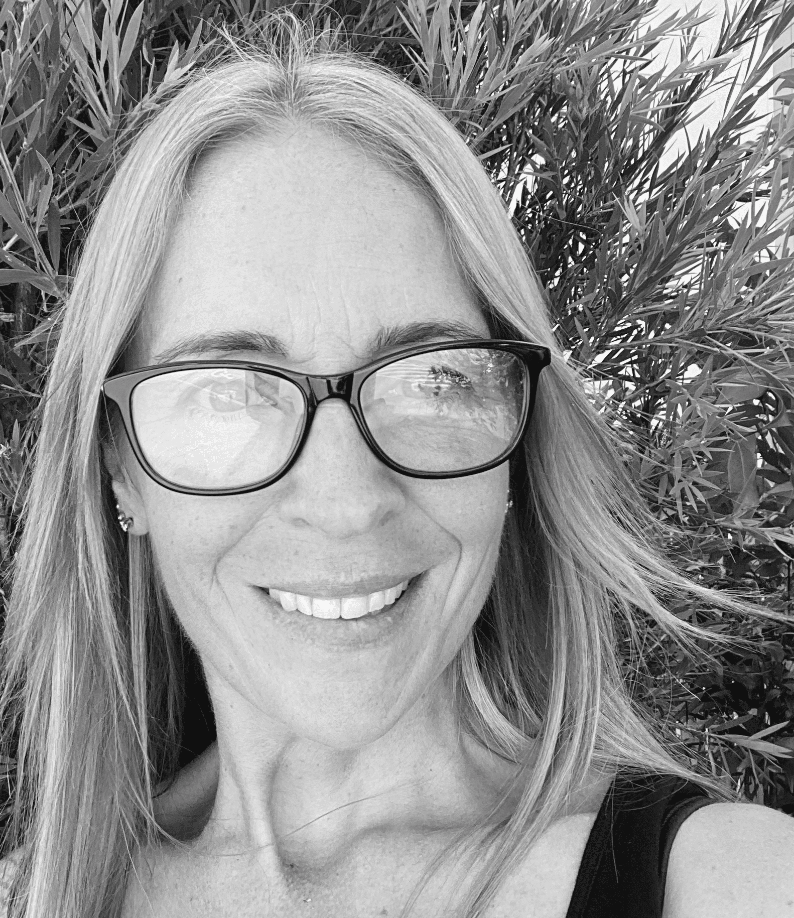 Cecilia Bailey, naturopath specializing in hormones, gut health, stress management, autoimmune conditions, and children's health, smiling outdoors with greenery in the background.