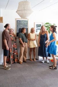Group of diverse individuals engaging in a friendly discussion at the Integrated Wellness Clinic, promoting a supportive atmosphere for naturopathic consultations.