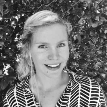 Shani Sulter, Naturopath Team Leader at Integrated Wellness Clinic, smiling in front of green foliage, promoting personalized health solutions and naturopathy services.